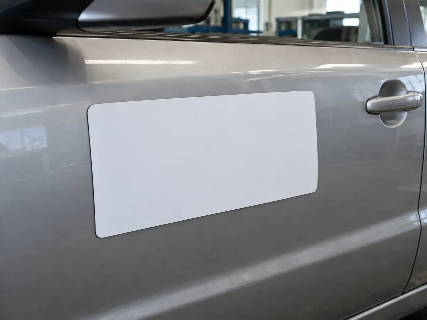 Blank magnetic sign on a car door.